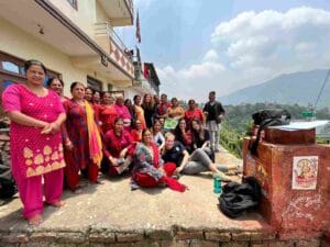 after women leading community meetings photo
