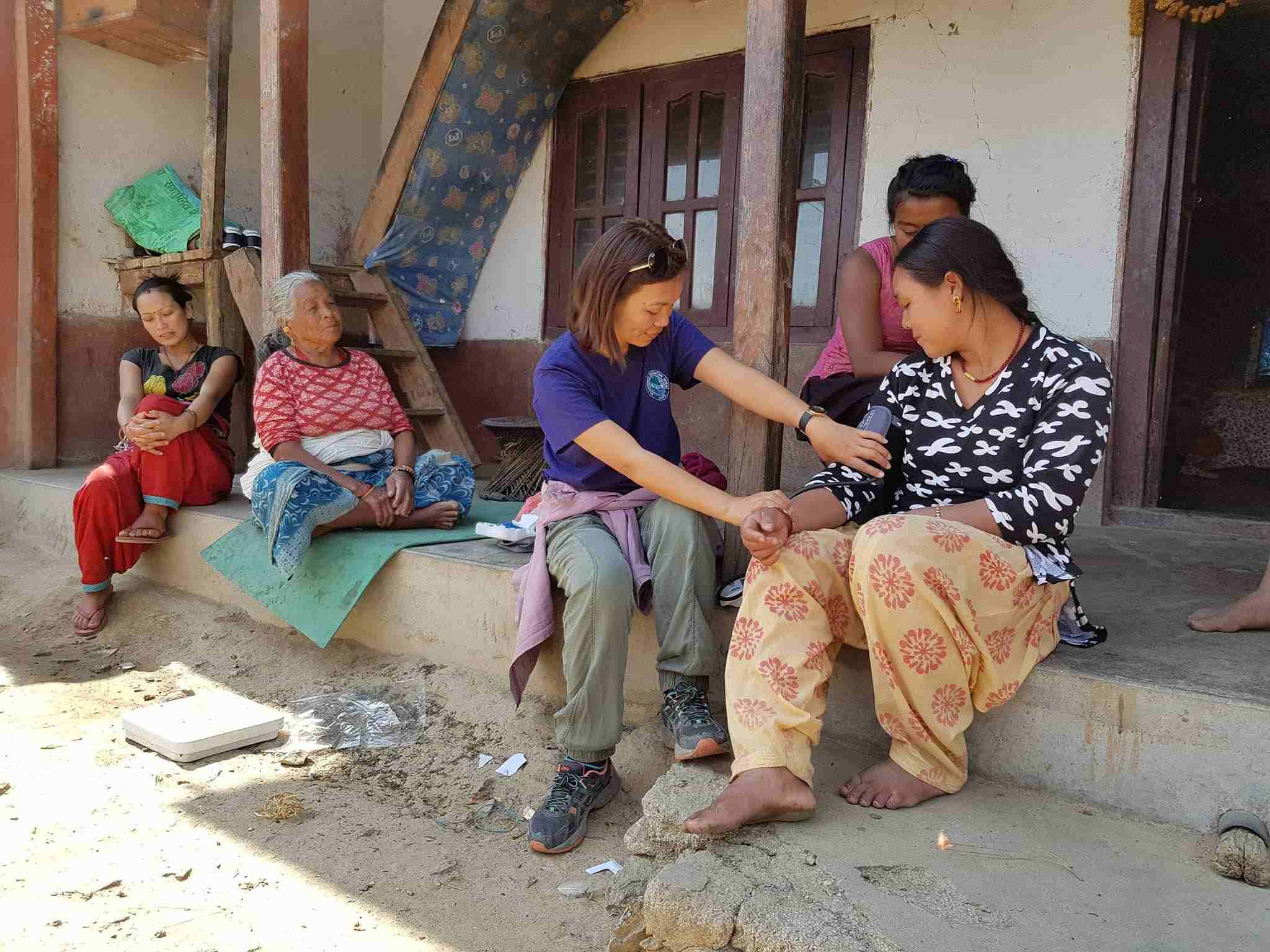 Medical volunteer Nepal conducting a health check-up in rural clinic