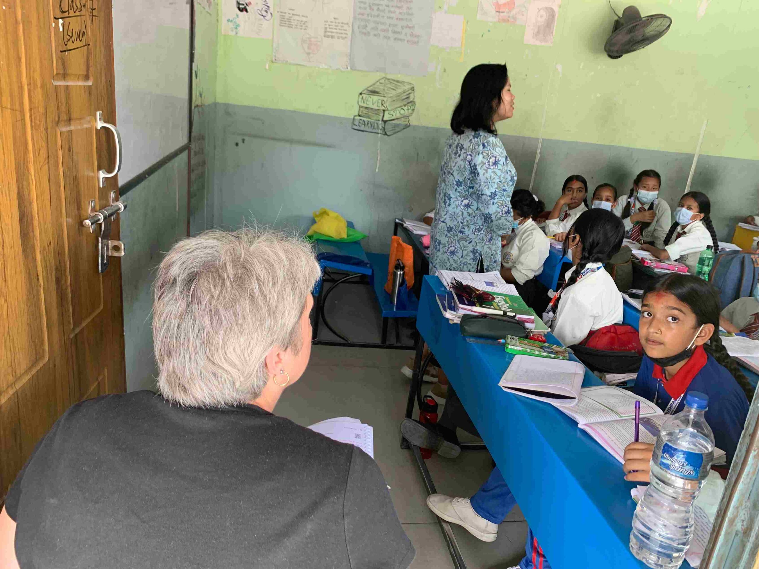 Volunteer teaching geometry to students in rural Nepal