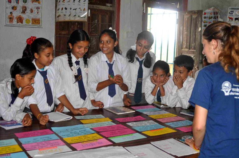 Volunteer teaching children in Nepal to enhance educational support