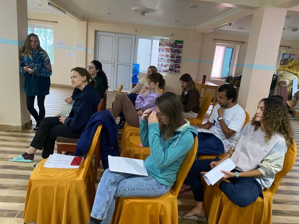 Volunteers and staff attend a community engagement meeting in Okhaldhunga, Nepal, discussing local development and project collaboratio